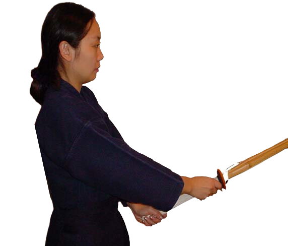 Woman in kendo uniform facing right, holding a shinai correctly. Left hand is at the bottom of the shinai handle. Right hand is directly under the hand guard.